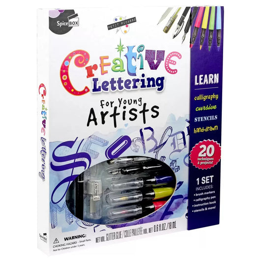 Open Petit Picasso Creative Lettering box set showcasing the instruction manual, art pad, dip pen, ink bottle, brush markers, and stencils neatly arranged inside.