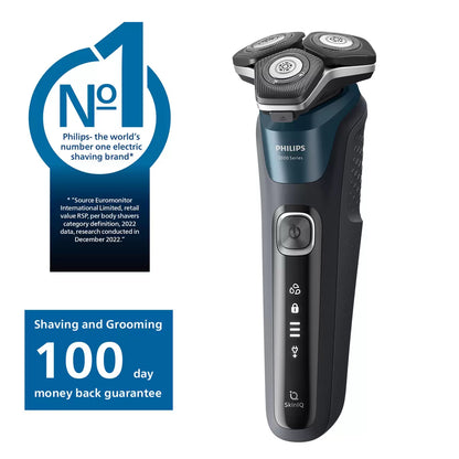 Philips Series 5000 electric shaver in a metallic finish, displayed with its nose trimmer accessory and travel case on a clean bathroom shelf.