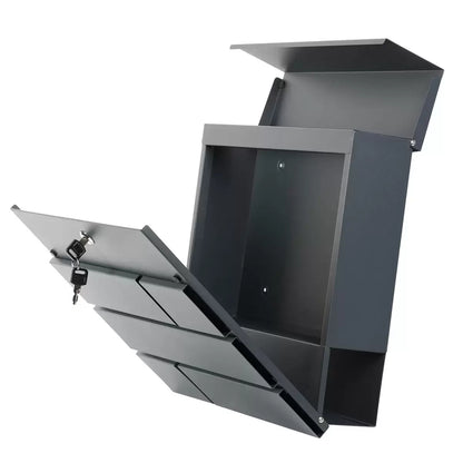 A close-up product photograph of the modern graphite grey Phoenix Estilo letter box mounted securely on an exterior brick wall, showing its matte powder-coated finish and secure key entry.