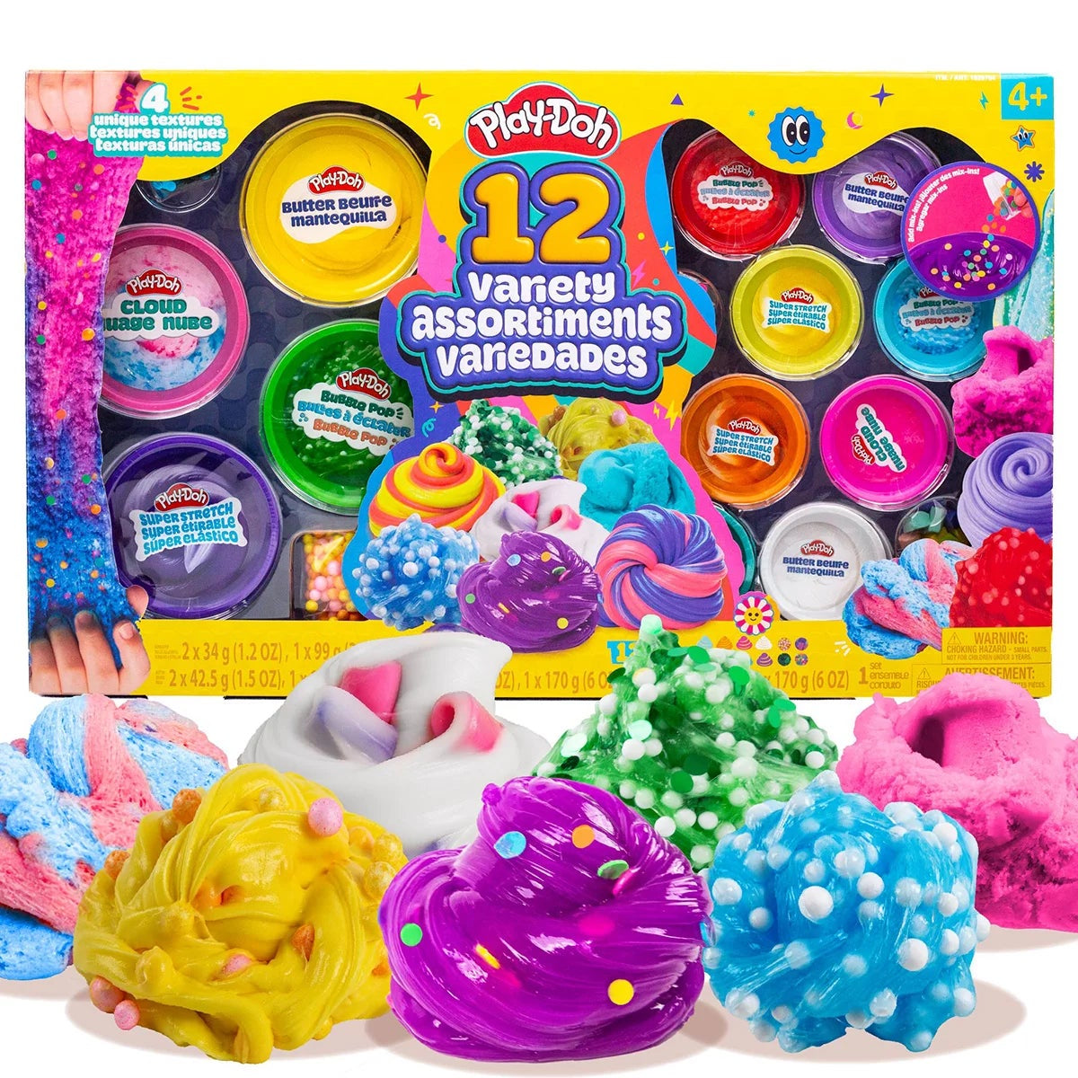 Top view of 12 colorful Play-Doh slime and sand tubs with foam marshmallow mix-ins and molding accessories arranged on a white table.