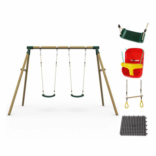 A Plum Ultimate premium wooden swing set standing in a lush green garden, featuring an assembled frame with a baby seat and trapeze attached, plus safety mats underneath.
