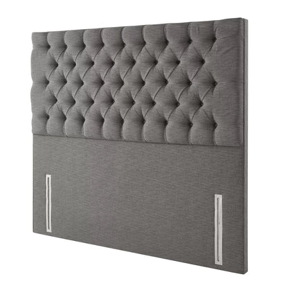 Front view of the floor-standing Pocket Spring Bed Company Ravello headboard upholstered in deep plush grey Chesterfield buttoned fabric mounted behind a dressed divan bed.
