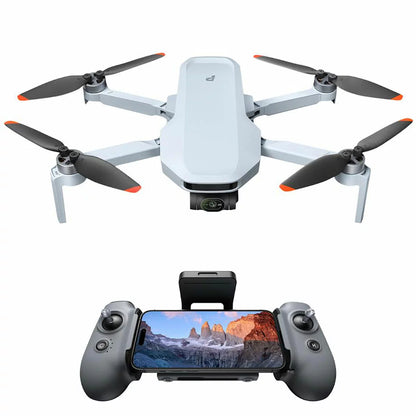 Top-down angle of the matte gray Potensic Atom 2 drone surrounded by its Fly More accessories, extra batteries, carrying case, and 128GB SD card on a dark slate background.