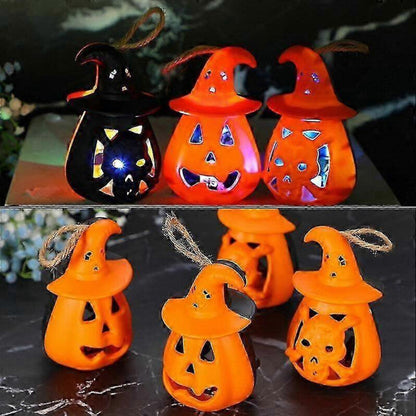 A 12-pack of mini pumpkin and skeleton LED battery-operated tea lights glowing warmly on a festive wooden party table.