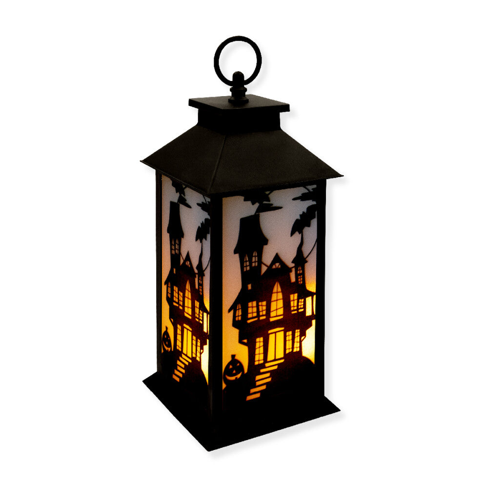 A 30.5cm black Victorian-style Global Gizmos LED Halloween lantern featuring a flickering orange candle effect and haunted house panels sitting on a wooden surface.