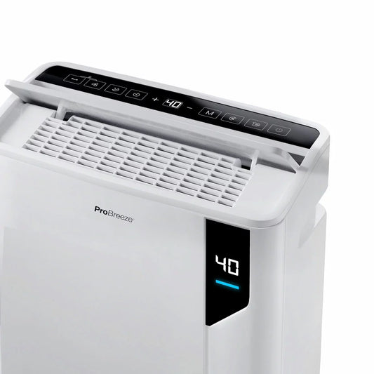 White rectangular Pro Breeze 20L premium dehumidifier standing upright on a modern hardwood floor next to an indoor clothes drying rack.