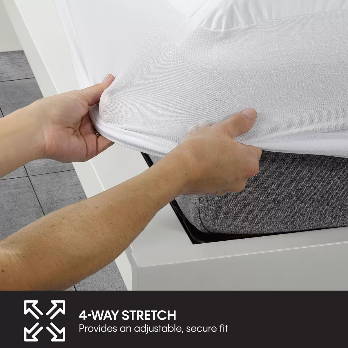 White Protect-A-Bed Cotton Mattress Protector fitted tightly over a mattress corner in a modern bedroom setting.