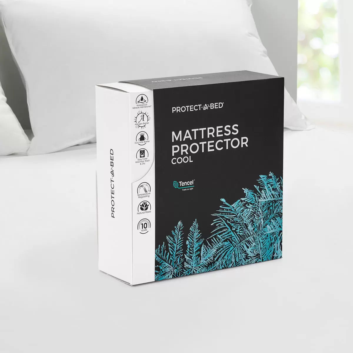 White Protect-A-Bed Tencel Cool Mattress Protector fitted smoothly over a thick mattress in a bright bedroom setting.