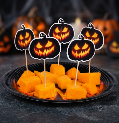Black and orange pumpkin paper cutouts on 12cm wooden cocktail sticks inserted into Halloween appetizers on a serving tray.