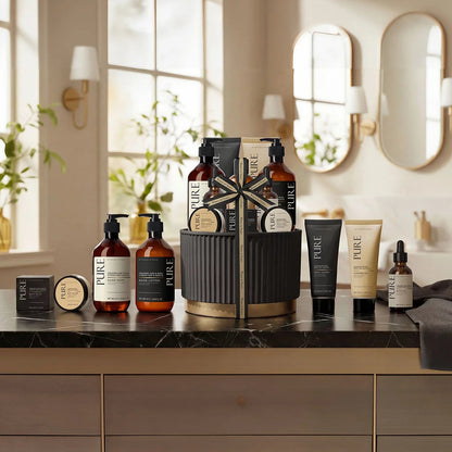 11-piece Pure Midnight Pot Gift Set with sandalwood citrus oils, lotion, and body wash arranged around a sleek dark decorative jar on a bathroom counter.