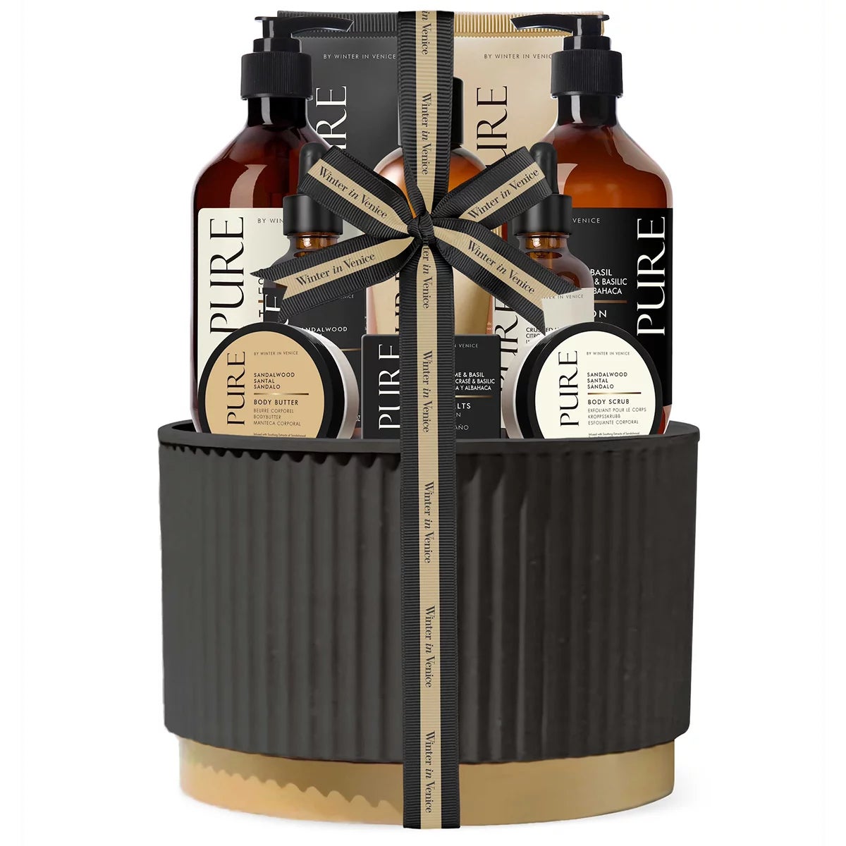 11-piece Pure Midnight Pot Gift Set with sandalwood citrus oils, lotion, and body wash arranged around a sleek dark decorative jar on a bathroom counter.