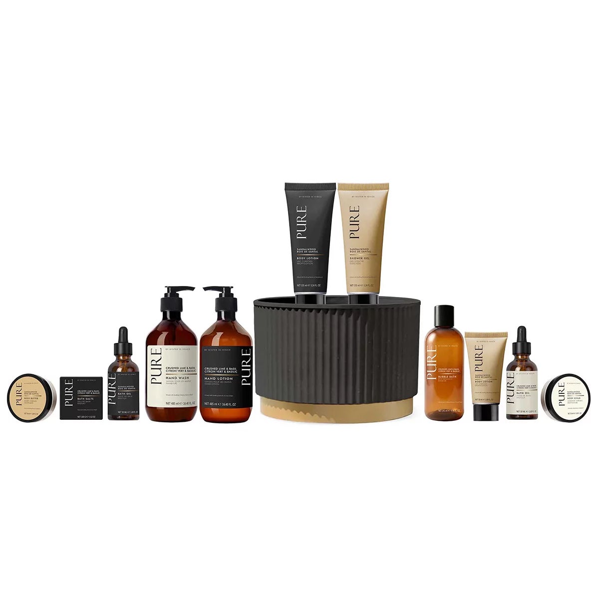 11-piece Pure Midnight Pot Gift Set with sandalwood citrus oils, lotion, and body wash arranged around a sleek dark decorative jar on a bathroom counter.