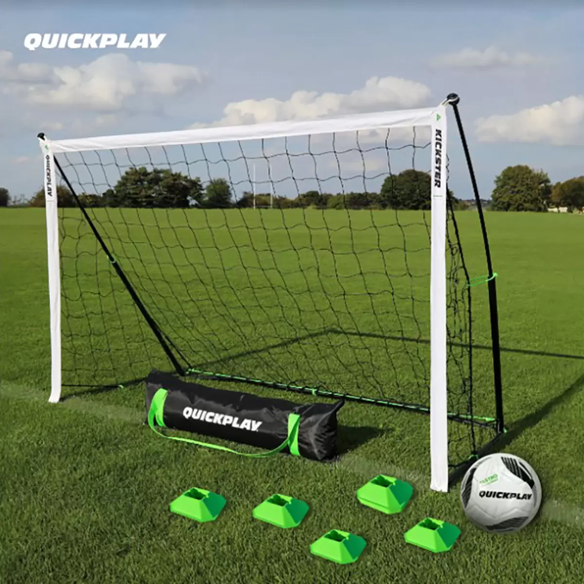 Complete Quickplay Kickster training kit set up on a manicured green grass pitch featuring the black and yellow frame goal, a Size 3 football, and bright orange mini cones spaced for agility drills.