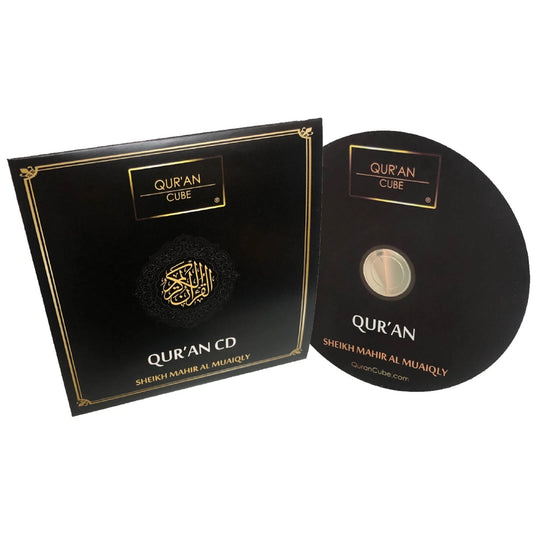 Quran CD MP3 disc resting inside its open jewel case alongside a printed track listing booklet on a dark wood surface.