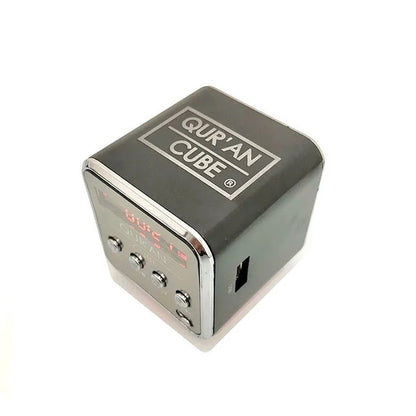 Miniature 4cm metallic Quran Cube Mini Speaker sitting inside its opened black and gold gift box alongside the Aux cable and Surah booklet.