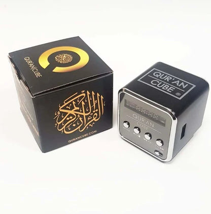 Miniature 4cm metallic Quran Cube Mini Speaker sitting inside its opened black and gold gift box alongside the Aux cable and Surah booklet.