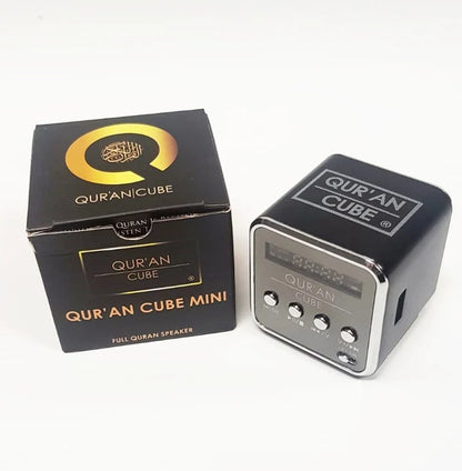 Miniature 4cm metallic Quran Cube Mini Speaker sitting inside its opened black and gold gift box alongside the Aux cable and Surah booklet.