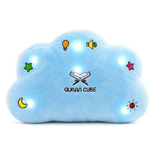 Soft yellow plush Quran Cube Dua Pillow showing stitched colorful button icons for Surahs and duas resting on a white bed sheet.