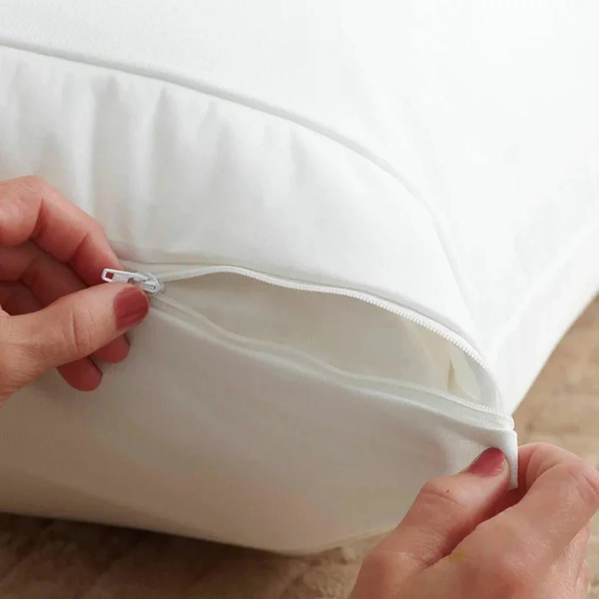 White REM-Fit cotton pillow protector smooth texture covering a standard pillow on crisp white bed linens