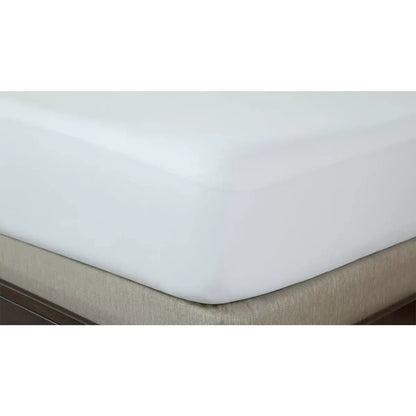 White REM-Fit Tencel Cool Mattress Protector stretched over a plush mattress corner in a minimalist modern bedroom.