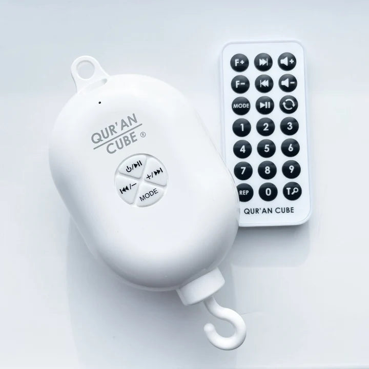 White electronic rechargeable cot mobile motor unit with control buttons resting on a neutral background.