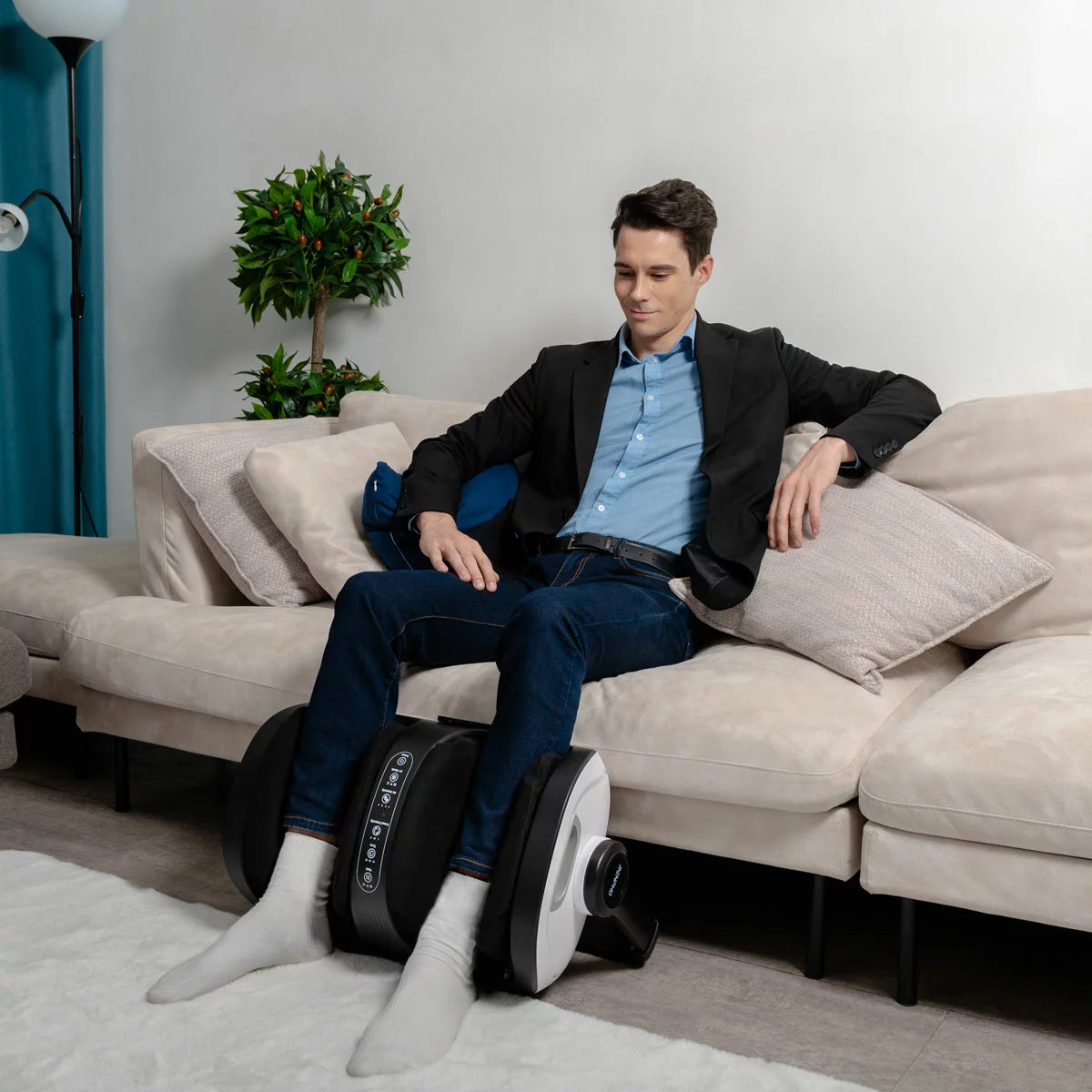 The Renpho 2-in-1 foot and calf massager in white, showcasing its ergonomic design and magnetic remote control set against a modern living room floor.