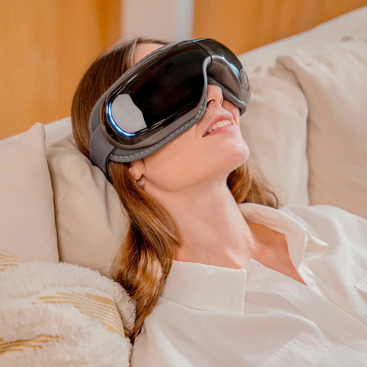 The Renpho Eyeris 3 eye massager in black, shown folded next to its storage bag, highlighting the sleek, foldable design and comfortable eye cushion.