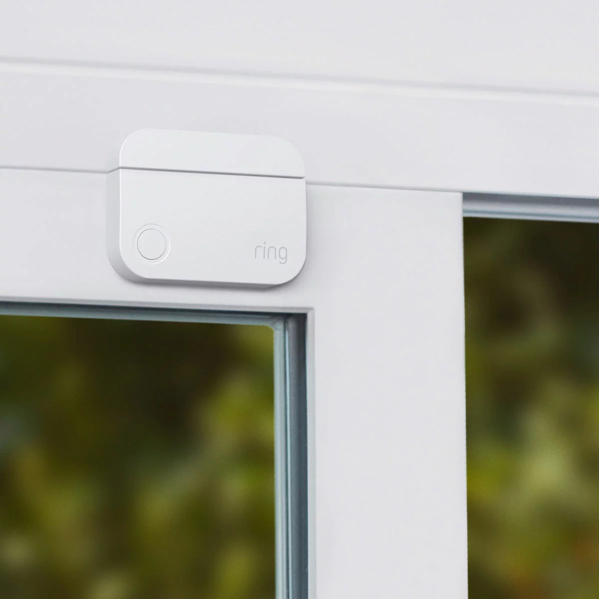 Flat lay arrangement of the white Ring 10 Piece Alarm 2nd Gen Starter Kit showing base station, keypad, indoor camera, contact sensors, motion detectors, and range extender against a neutral backdrop.