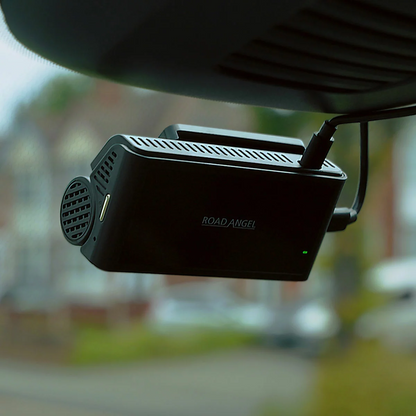 Cylindrical matte black screenless Road Angel Halo Ultima 4K front dash cam and its matching compact rear lens mounted flush on a clean vehicle windscreen.