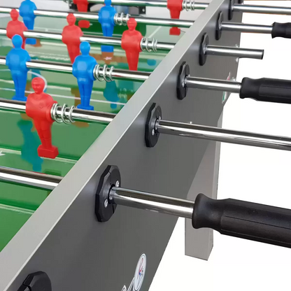 Side view of the wood-grain finish Roberto Sport 4ft Game Football Table standing on square black iron legs, showcasing its solid steel rods and blue and red miniature players.