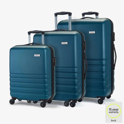 Front view of the vibrant teal Rock Byron 3 piece hardside luggage set lined up on a polished stone terminal floor showing the cabin, medium, and large suitcases.