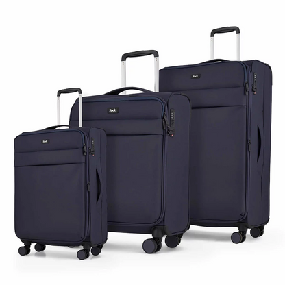 Front angle view of the Rock Harper 3 piece softside luggage set in charcoal grey showing nested cabin, medium, and large expandable suitcases on a modern airport lounge floor.