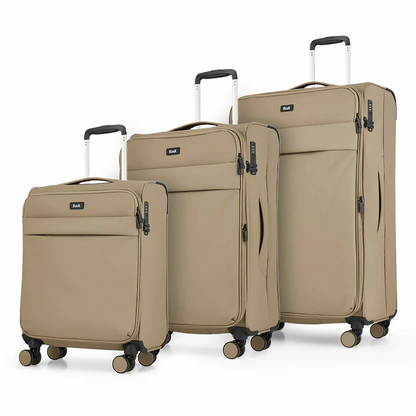 Front angle view of the Rock Harper 3 piece softside luggage set in charcoal grey showing nested cabin, medium, and large expandable suitcases on a modern airport lounge floor.