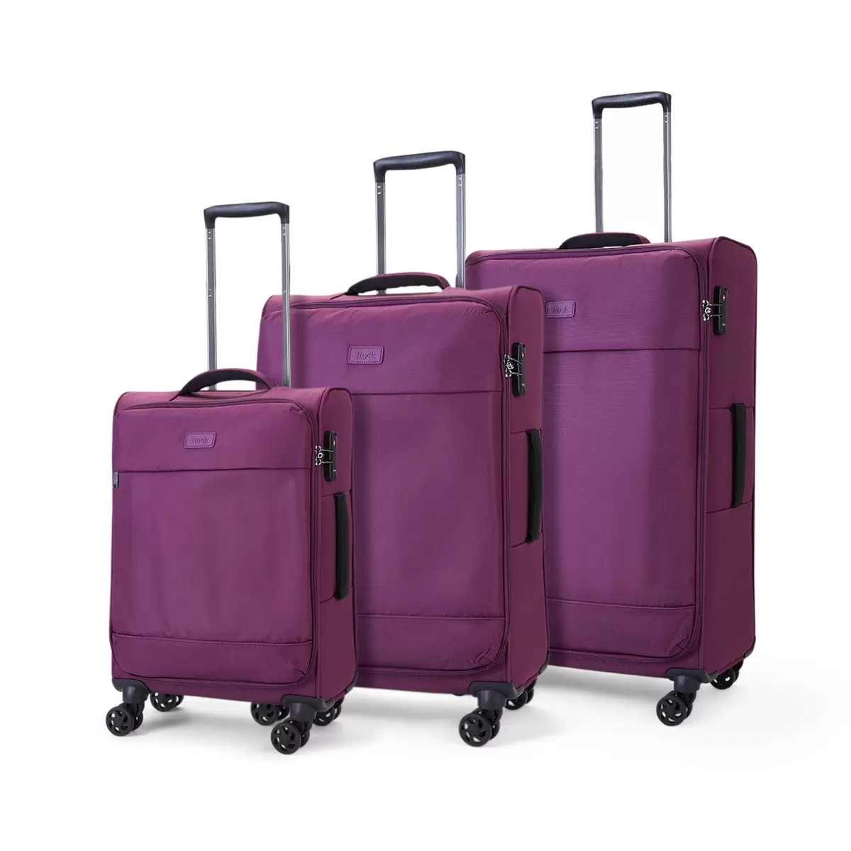 Rock Paris 3 piece softside luggage set displayed side by side in four distinct colors on a polished hardwood floor in a sunlit entryway.