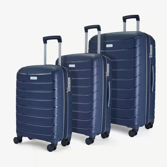 Front three-quarter view of the Rock Prime 3 piece hardside luggage set in charcoal grey showing textured shell lines and spinner wheels.