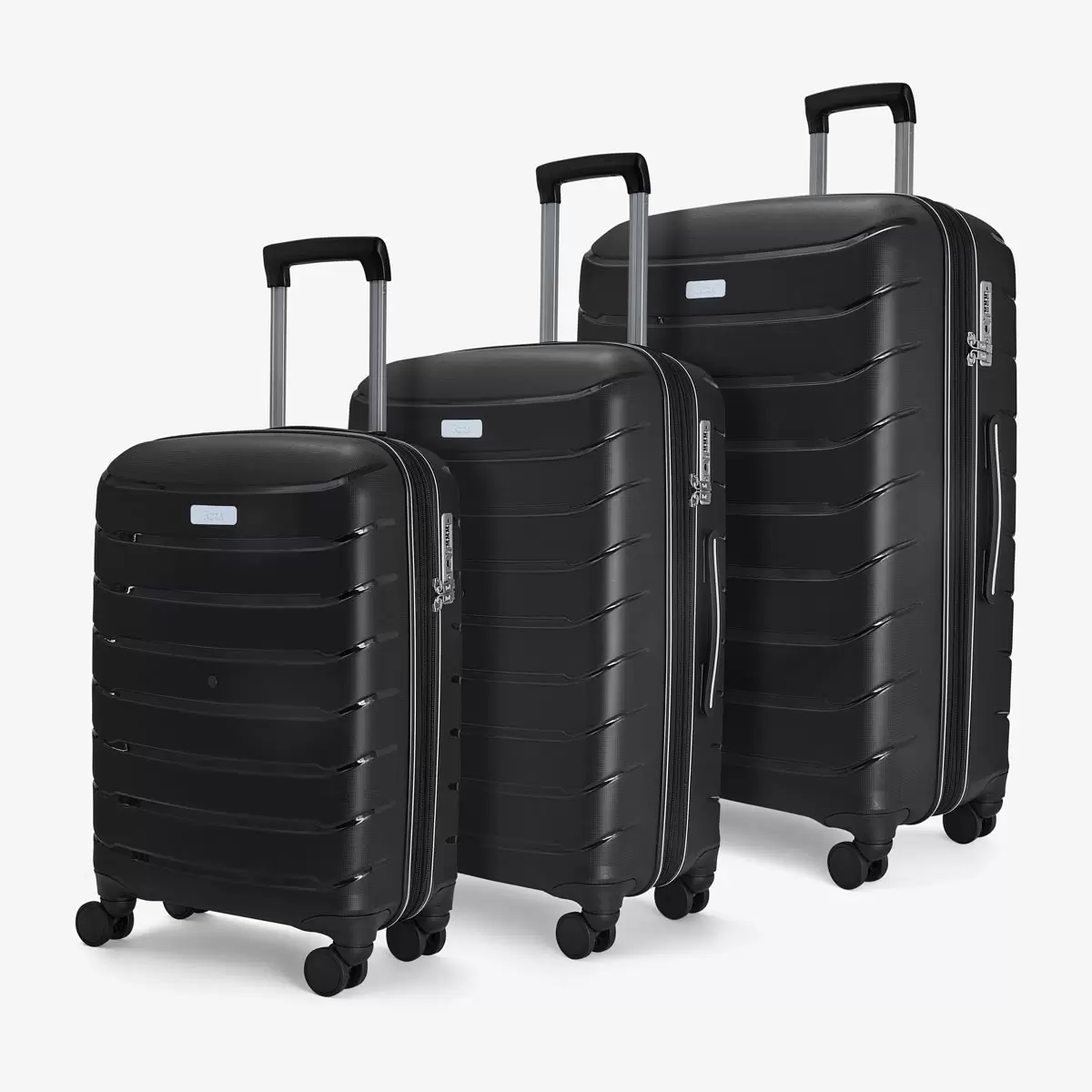 Front three-quarter view of the Rock Prime 3 piece hardside luggage set in charcoal grey showing textured shell lines and spinner wheels.