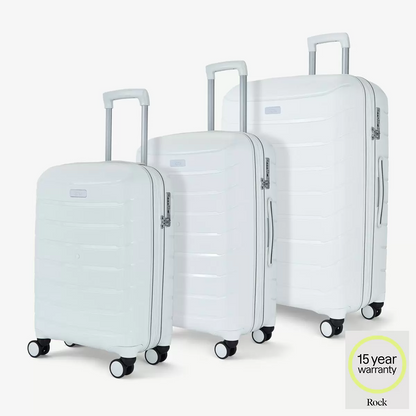 Front three-quarter view of the Rock Prime 3 piece hardside luggage set in charcoal grey showing textured shell lines and spinner wheels.