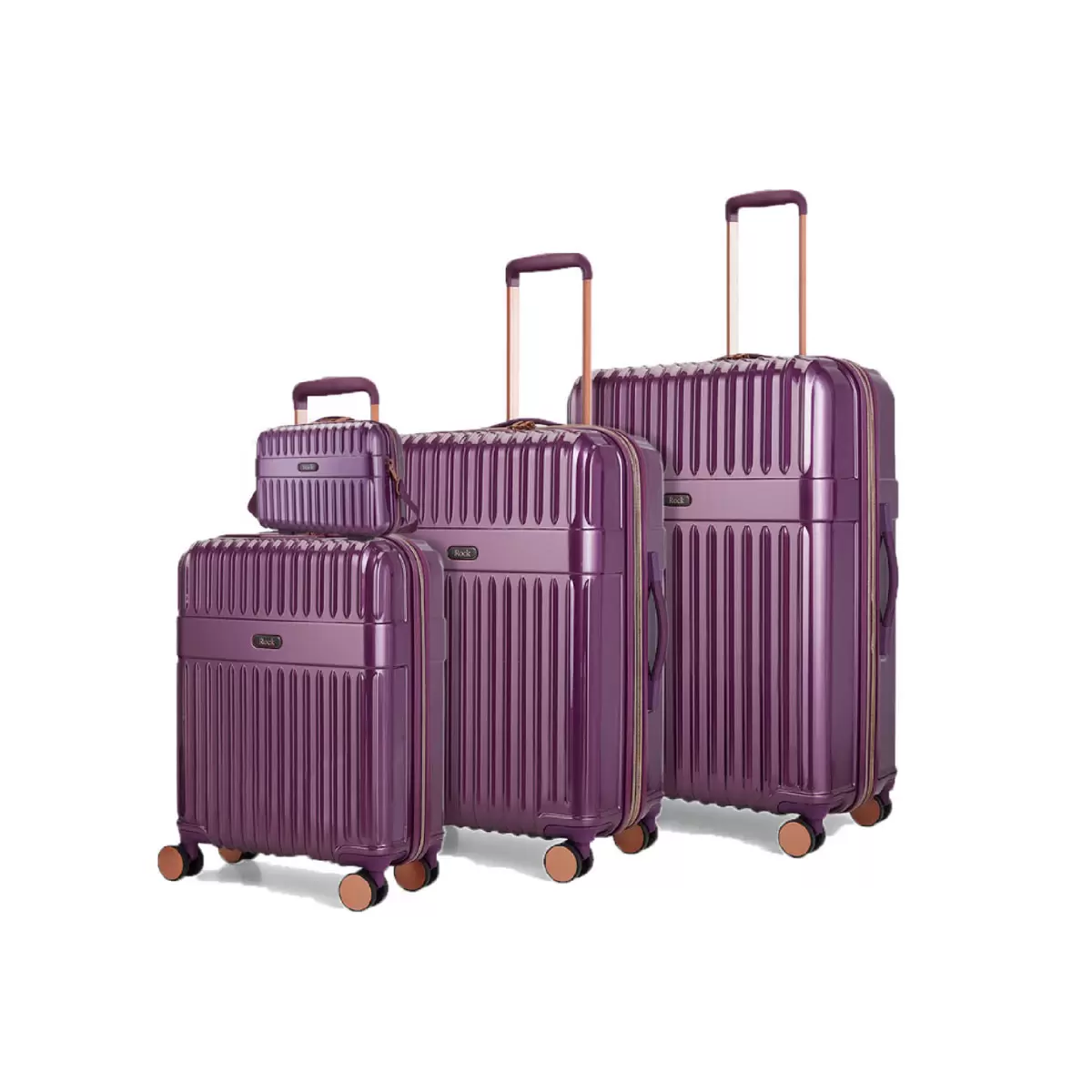 Front angle of four-piece Rock Selene hardside luggage set including vanity case with copper accents standing on a marble floor.
