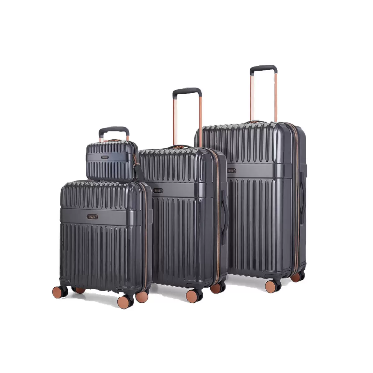 Front angle of four-piece Rock Selene hardside luggage set including vanity case with copper accents standing on a marble floor.