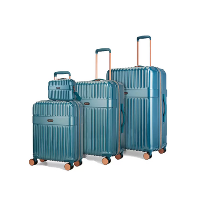 Front angle of four-piece Rock Selene hardside luggage set including vanity case with copper accents standing on a marble floor.