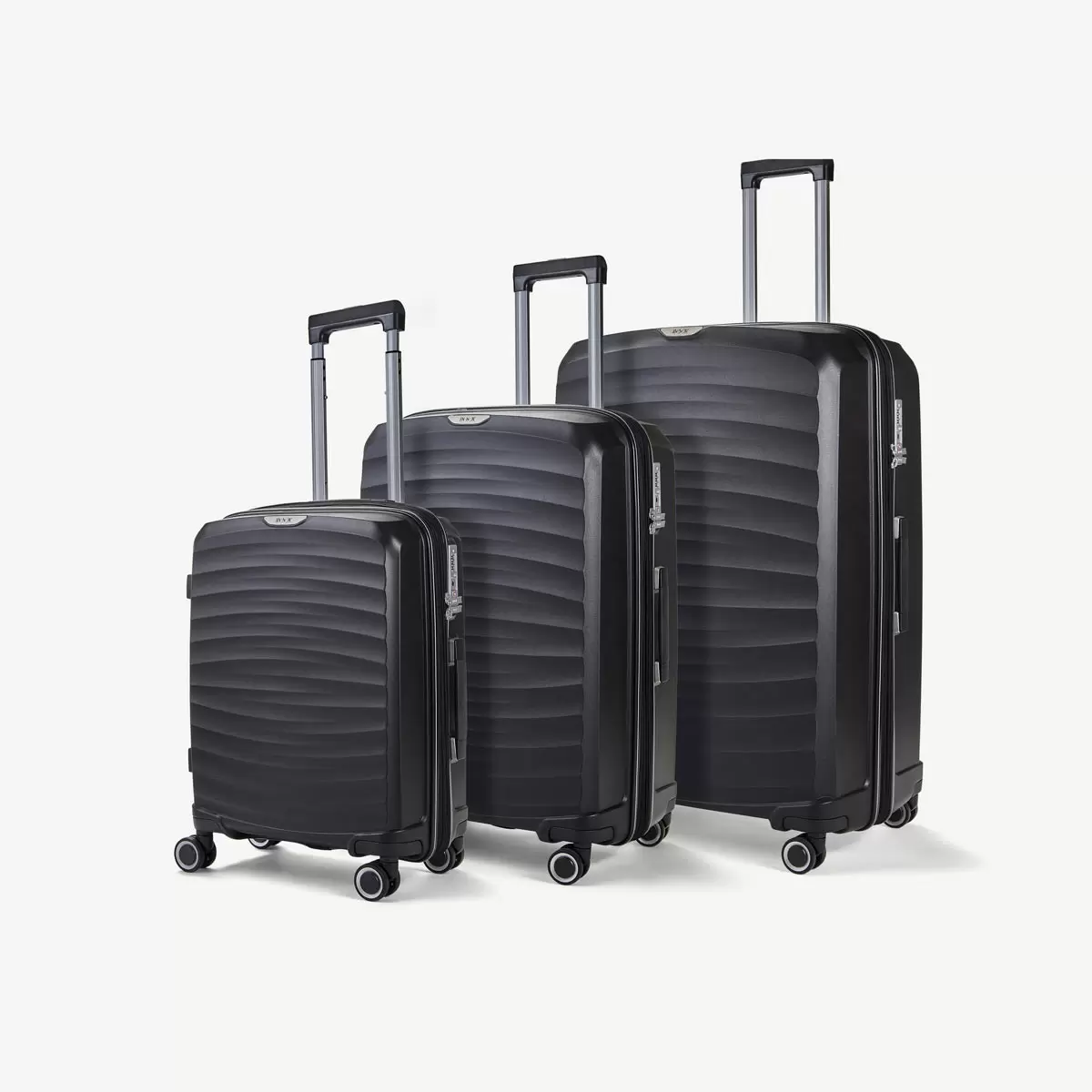 Three-quarter angle of three ocean-blue Rock Sunwave hardside suitcases stacked in cabin, medium, and large sizes on a glossy terminal floor.