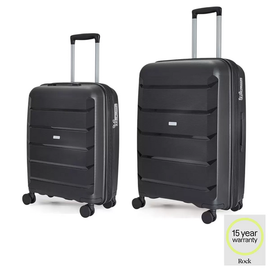 Rock Tulum 2 piece hardside luggage set showing cabin and medium suitcases stacked side by side in a sleek modern terminal.