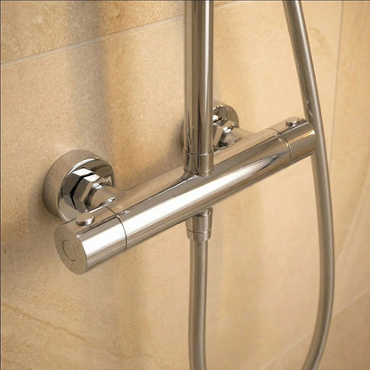 Polished chrome Roper Rhodes Hydroforce exposed bar shower system with 250mm circular overhead head and multi-function handset mounted on a light tile bathroom wall.