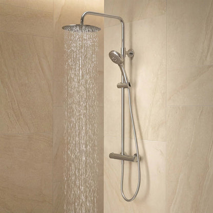 Polished chrome Roper Rhodes Hydroforce exposed bar shower system with 250mm circular overhead head and multi-function handset mounted on a light tile bathroom wall.