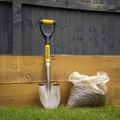 Flat lay of the 6 piece Roughneck tool kit featuring an 8lb sledge hammer, club hammer, bolster chisel, Gorilla bar, micro shovel, and pick axe on a concrete surface.