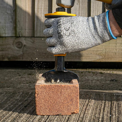 Flat lay of the 6 piece Roughneck tool kit featuring an 8lb sledge hammer, club hammer, bolster chisel, Gorilla bar, micro shovel, and pick axe on a concrete surface.