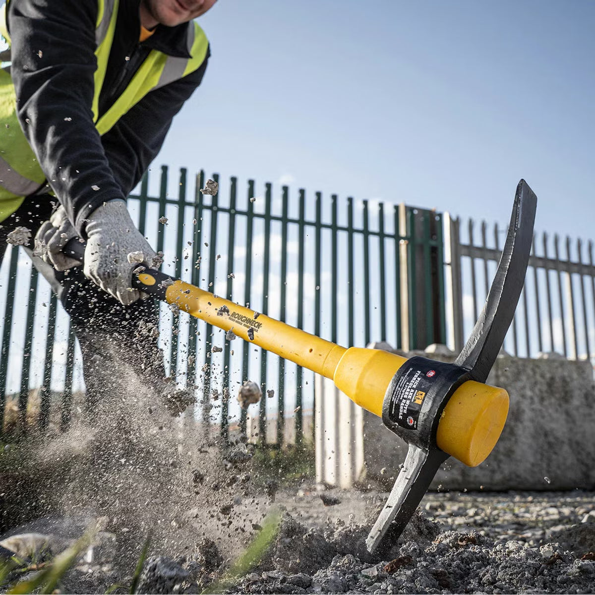 Flat lay of the 6 piece Roughneck tool kit featuring an 8lb sledge hammer, club hammer, bolster chisel, Gorilla bar, micro shovel, and pick axe on a concrete surface.