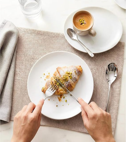 Front view of the 16-piece silver Russell Hobbs London stainless steel cutlery set arranged neatly on a wooden dining table.