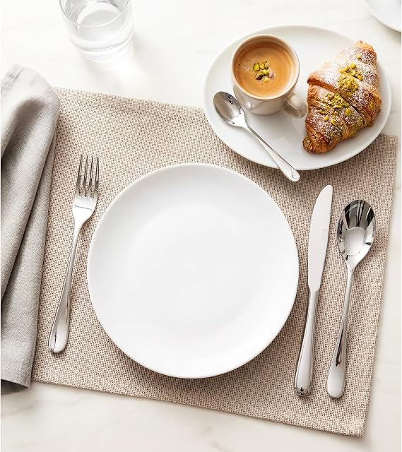 Front view of the 16-piece silver Russell Hobbs London stainless steel cutlery set arranged neatly on a wooden dining table.