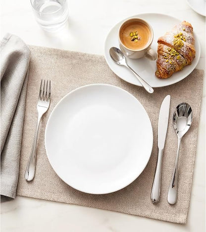 Front view of the 16-piece silver Russell Hobbs London stainless steel cutlery set arranged neatly on a wooden dining table.